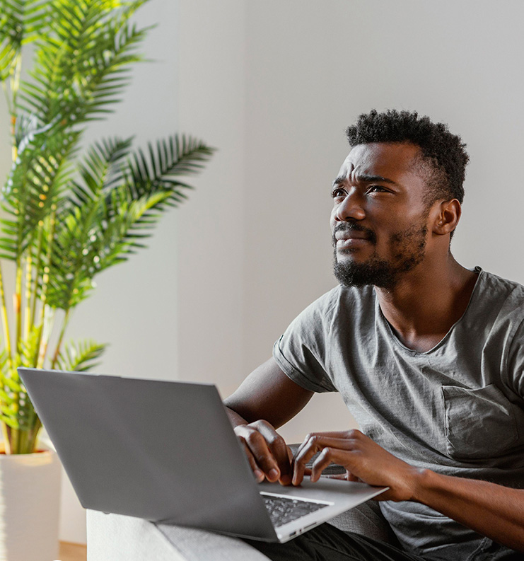 Person looking concerned while using a laptop